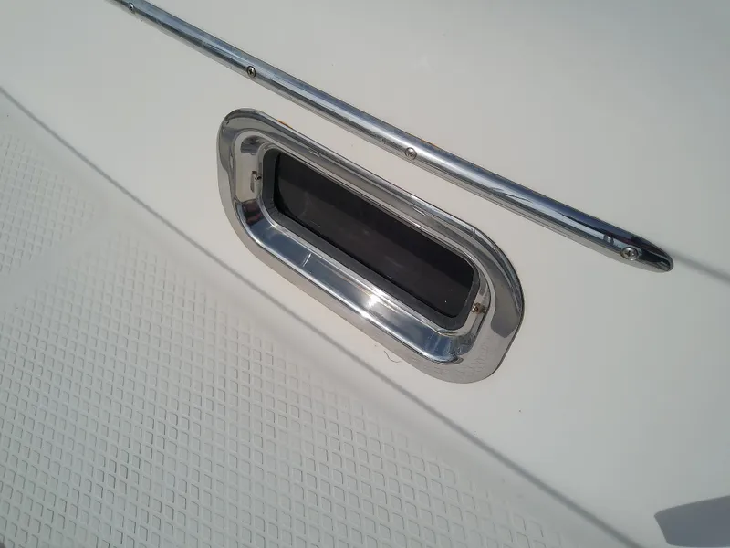 Slide: The Image of Close-up of a 2017 Hake Seaward 32RK boat window with chrome trim. - 28