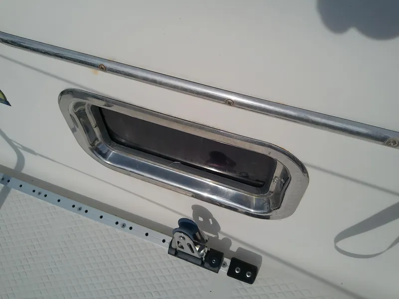 Slide: The Image of 2017 Hake Seaward 32RK boat window with chrome frame and deck detail. - 31