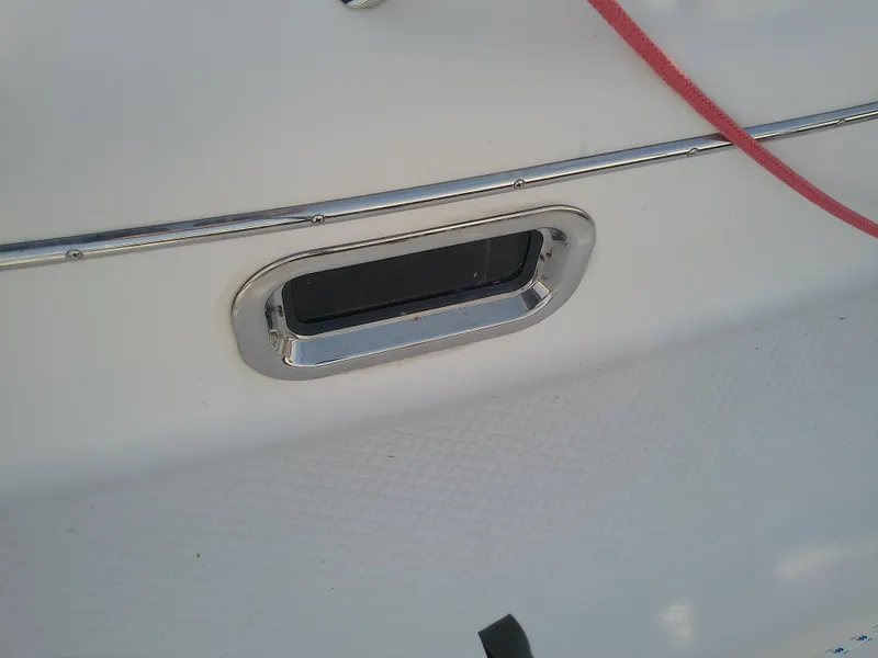 Slide: The Image of Close-up of a 2017 Hake Seaward 32RK boat porthole with red rope. - 33