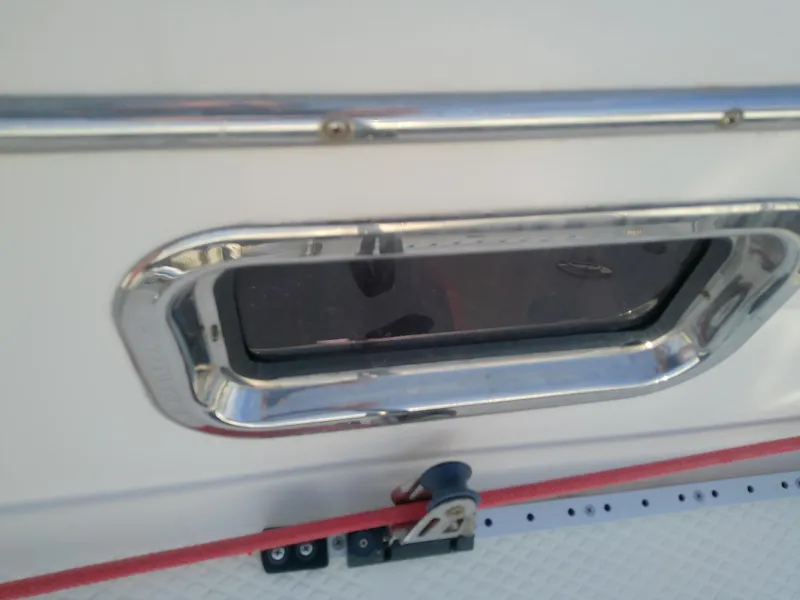 Slide: The Image of Close-up of a 2017 Hake Seaward 32RK boat window with chrome trim. - 35