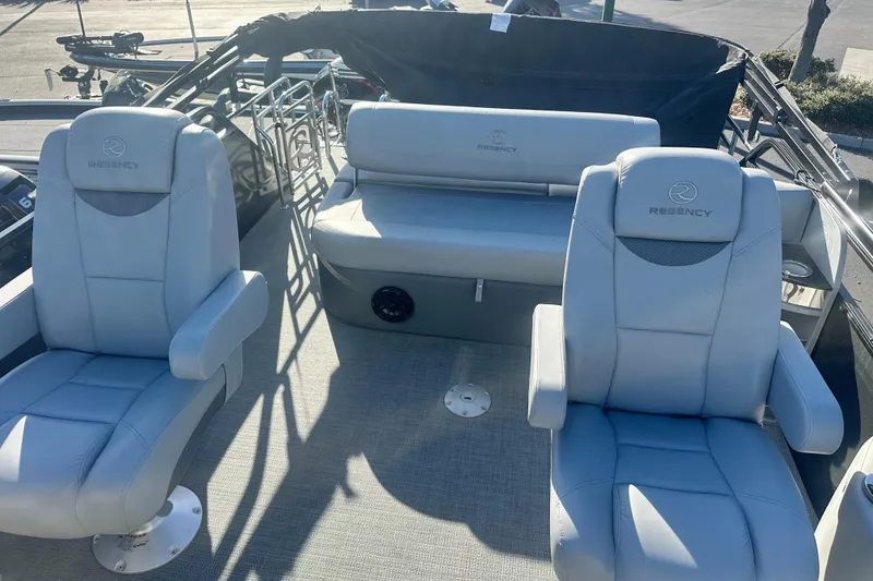 Slide: The Image of 2024 Regency R230LE3 SPT boat interior with plush seating and modern design. - 4