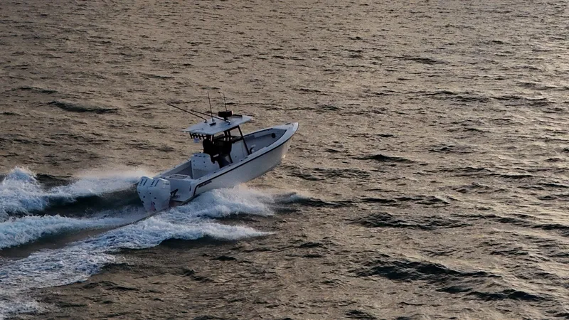 The Image of 2025 Reef Runner 280 boat cruising on open water under cloudy skies. - 0