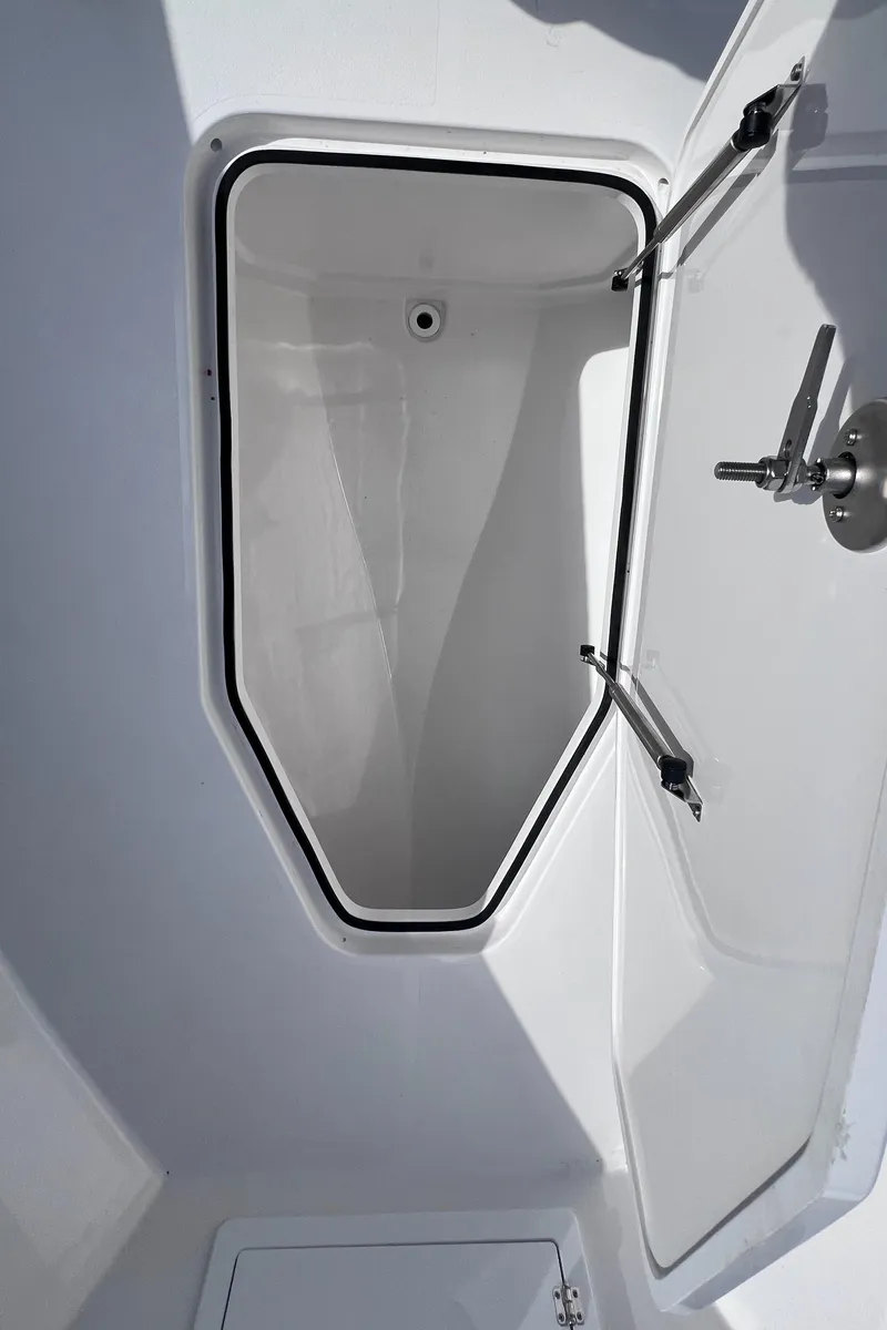 Slide: The Image of Open storage compartment on 2025 Reef Runner 280 boat. - 11