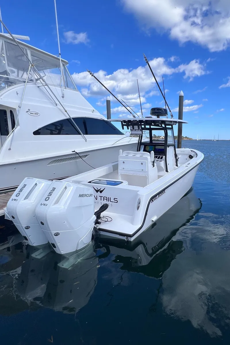 Slide: The Image of 2025 Reef Runner 280 boat cruising on open water at sunset. - 4