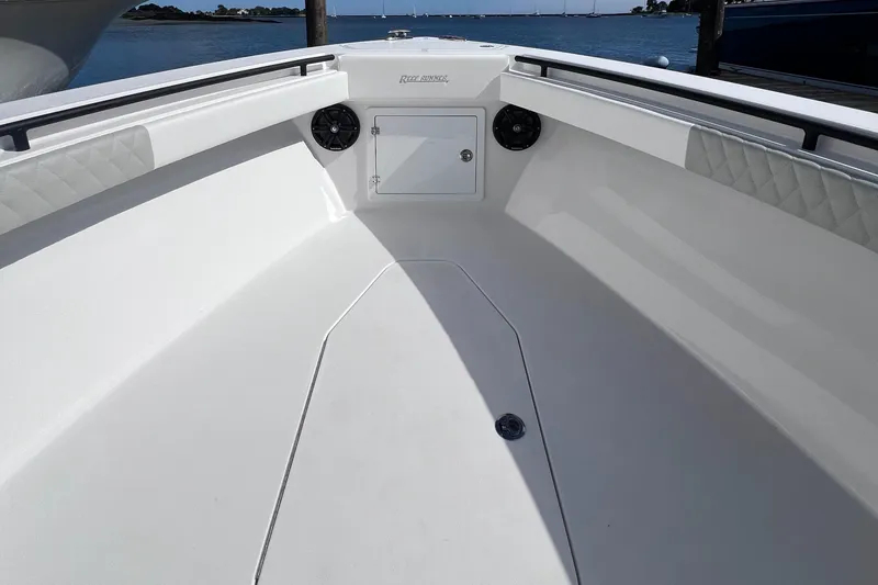 Slide: The Image of 2025 Reef Runner 280 boat interior with spacious white deck and storage compartment. - 9