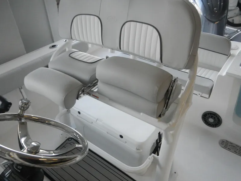 Slide: The Image of 2024 Sea Fox 228 Commander boat interior with cushioned seating and steering wheel. - 3