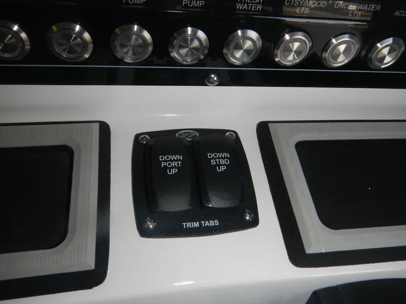 Slide: The Image of 2024 Sea Fox 228 Commander trim tab controls and dashboard buttons. - 5
