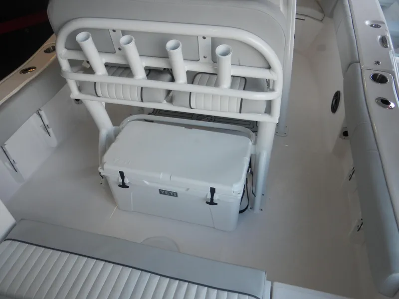 Slide: The Image of 2024 Sea Fox 228 Commander boat interior with rod holders and cooler. - 9