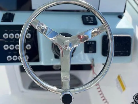 Slide: The Image of Steering wheel of 2024 Sea Pro 240DLX boat with control panel. - 10