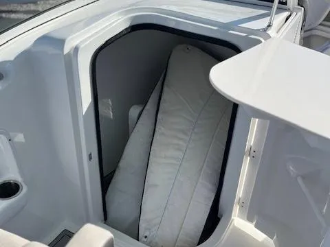 Slide: The Image of 2024 Sea Pro 240DLX boat storage compartment with cushion inside. - 11