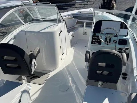 Slide: The Image of 2024 Sea Pro 240DLX boat interior with dual seats and modern dashboard. - 12