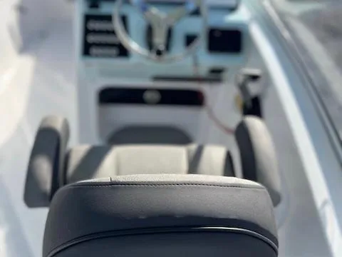 Slide: The Image of Interior view of 2024 Sea Pro 240DLX boat, featuring steering wheel and seating. - 6