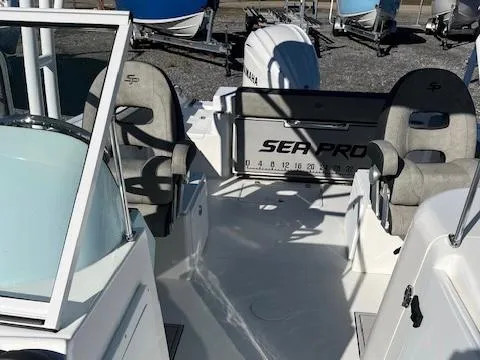 Slide: The Image of 2024 Sea Pro 240DLX boat interior with seating and Yamaha engine. - 8