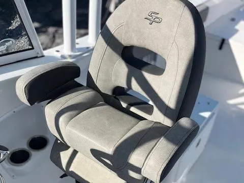 Slide: The Image of 2024 Sea Pro 240DLX boat seat with armrests and logo, in sunlight. - 9