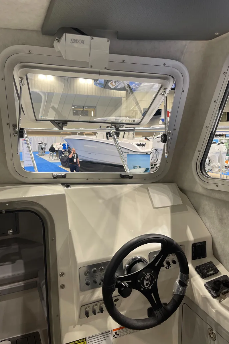 Slide: The Image of 2025 Defiance Admiral 250 EX interior seating with quilted upholstery and storage compartment. - 14