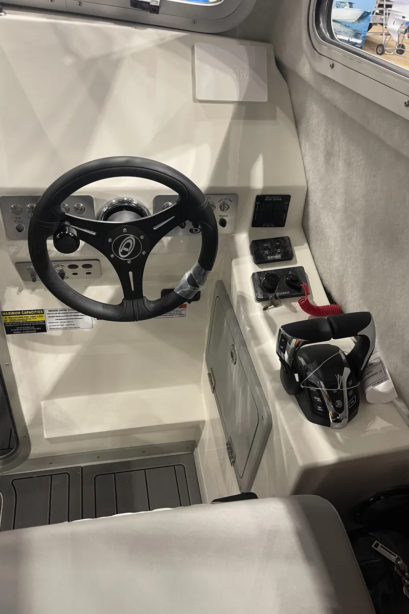 Slide: The Image of Interior seating of 2025 Defiance Admiral 250 EX boat, featuring quilted upholstery. - 15