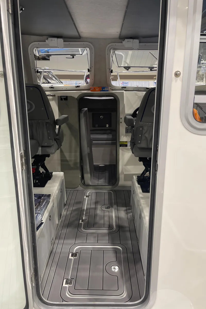 Slide: The Image of Interior of 2025 Defiance Admiral 250 EX boat with modern controls and seating. - 17