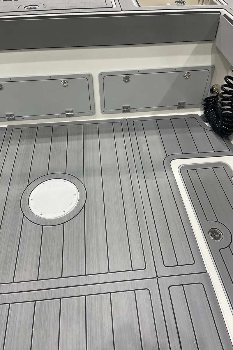 Slide: The Image of 2025 Defiance Admiral 250 EX boat side view in a parking lot. - 23