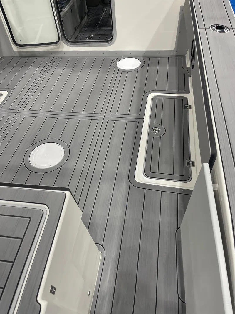Slide: The Image of 2025 Defiance Admiral 250 EX boat interior with seating and storage compartments. - 6