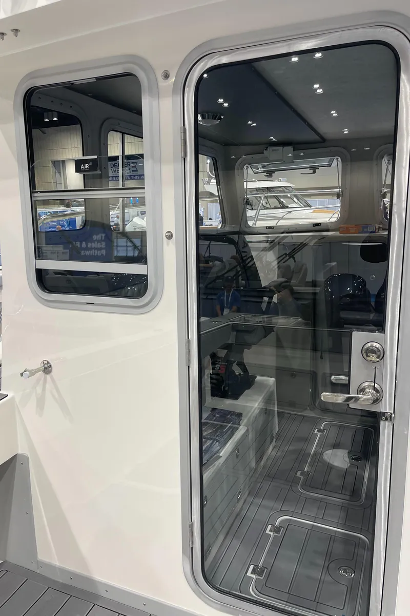 Slide: The Image of 2025 Defiance Admiral 250 EX cabin interior with Garmin GPS and compact toilet. - 20