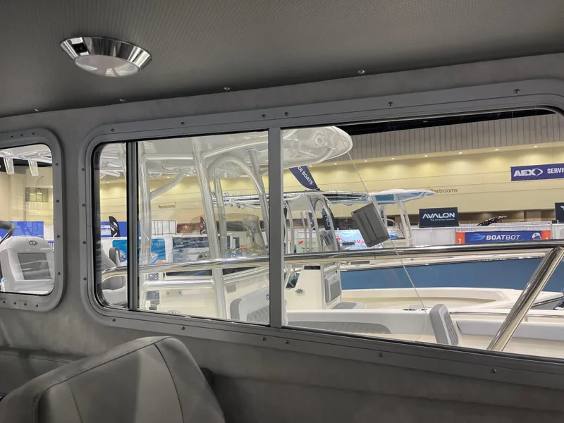 Slide: The Image of 2025 Defiance Admiral 250 EX boat deck with storage compartments and branding. - 4