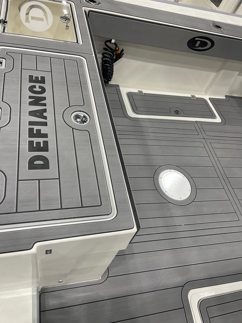 Slide: The Image of Open storage compartments on a 2025 Defiance Admiral 250 EX boat deck. - 7