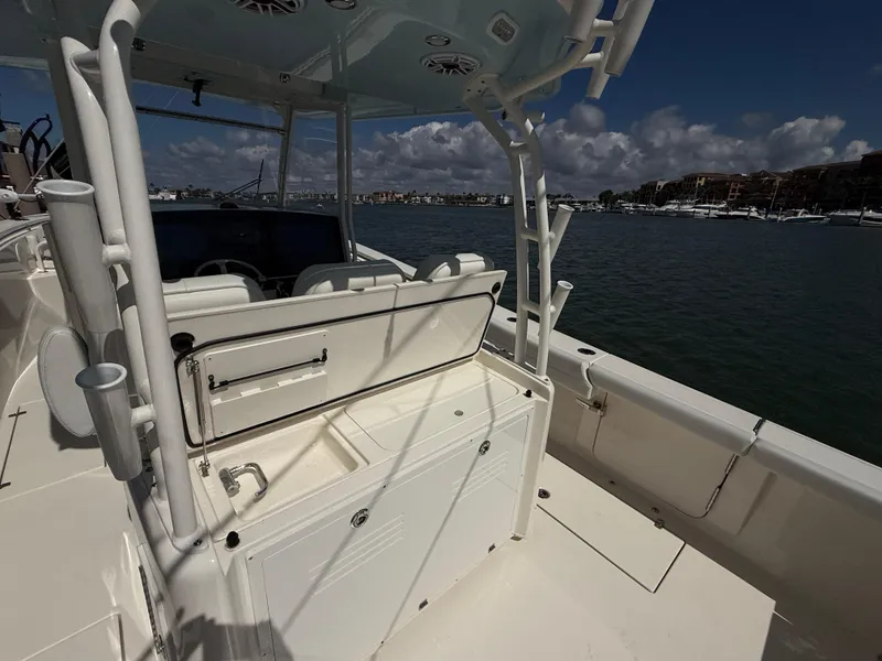Slide: The Image of 2023 Cobia 350 Center Console boat on water, featuring spacious deck and seating. - 13