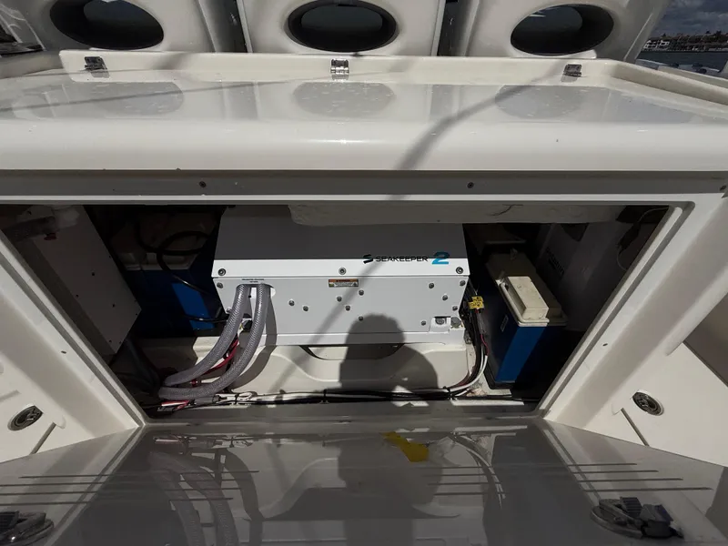 Slide: The Image of 2023 Cobia 350 Center Console boat's engine compartment with visible wiring and components. - 15