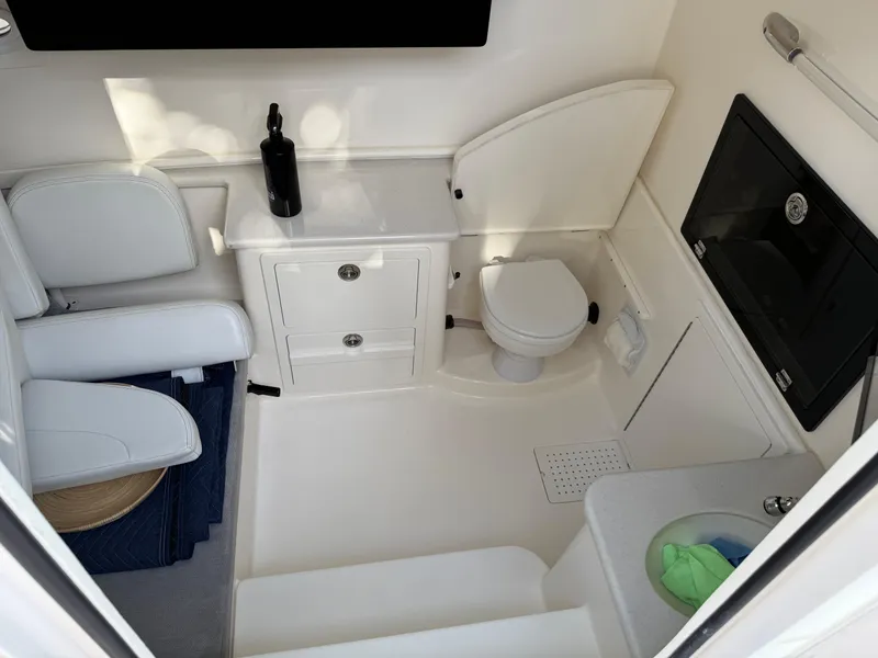 Slide: The Image of 2023 Cobia 350 Center Console boat interior with toilet and seating area. - 20