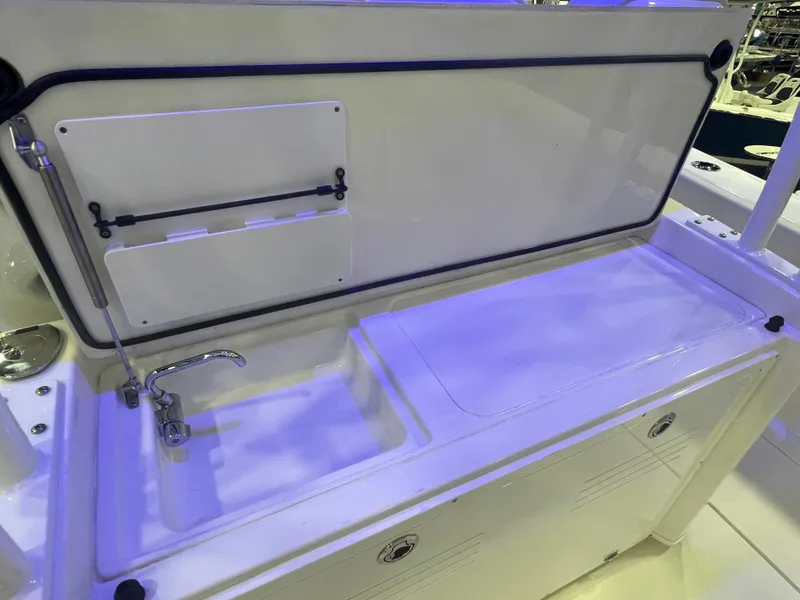 Slide: The Image of 2023 Cobia 350 Center Console boat sink and storage area. - 22