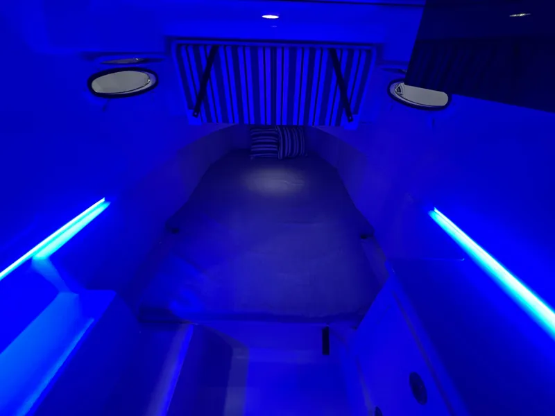 Slide: The Image of 2023 Cobia 350 Center Console cabin with blue LED lighting. - 23