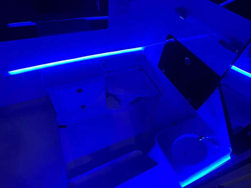 Slide: The Image of 2023 Cobia 350 Center Console interior with blue LED lighting. - 24