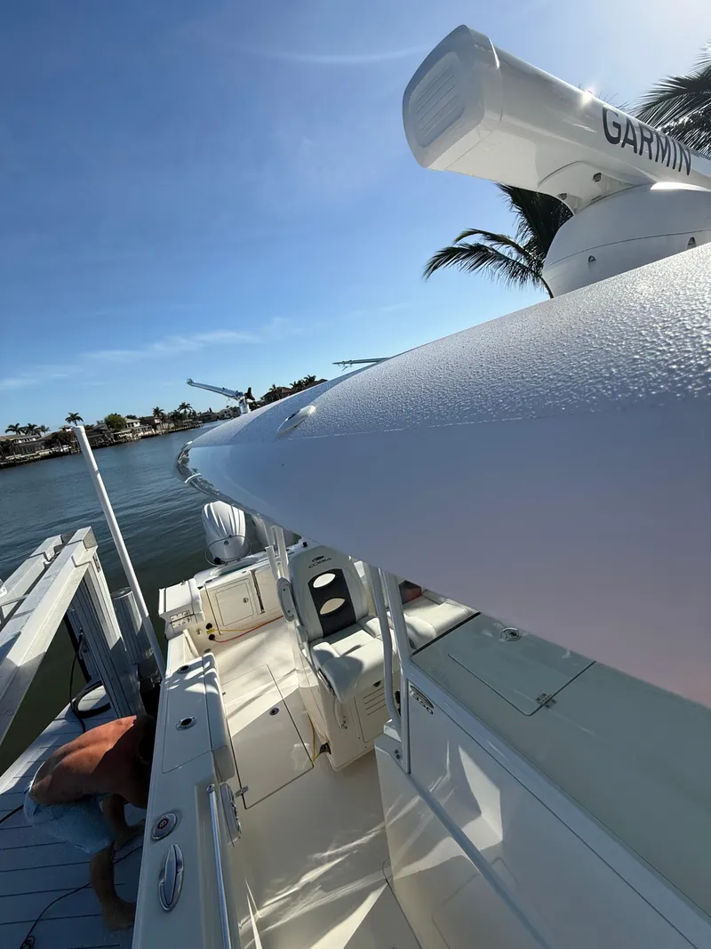 Slide: The Image of 2023 Cobia 350 Center Console boat docked by the water. - 30