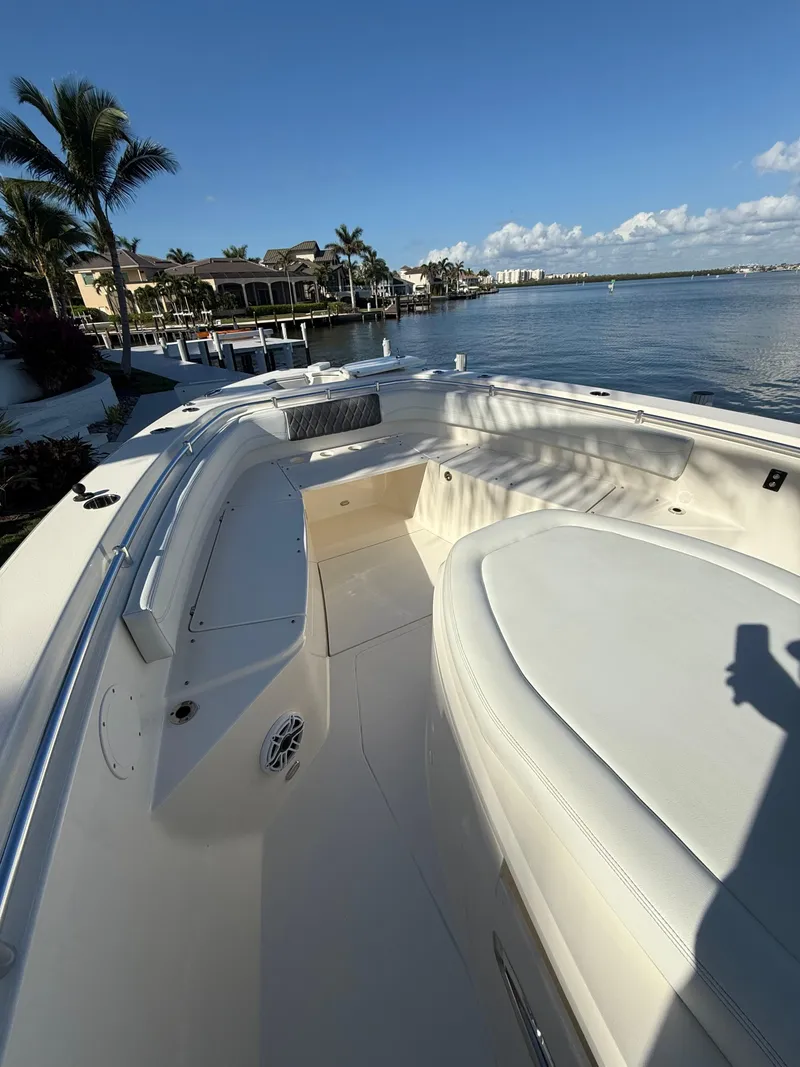 Slide: The Image of 2023 Cobia 350 Center Console boat docked by waterfront homes. - 34
