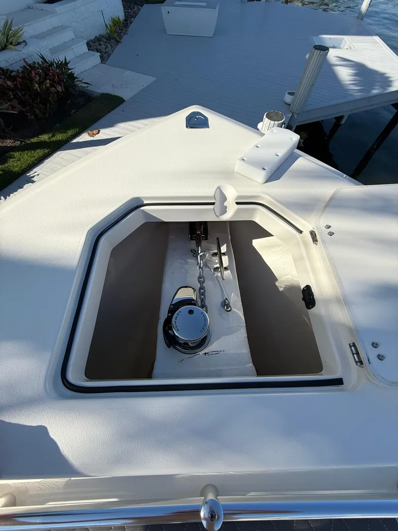 Slide: The Image of 2023 Cobia 350 Center Console anchor compartment on deck. - 35