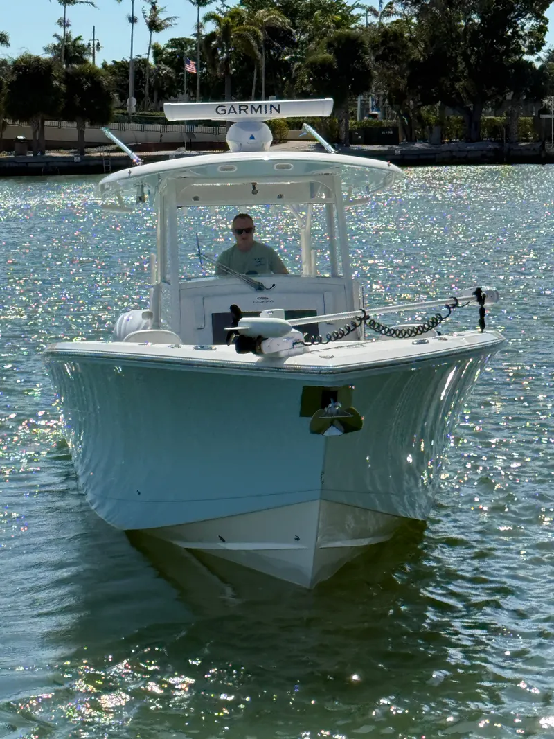 Slide: The Image of 2023 Cobia 350 Center Console boat on water, featuring Garmin equipment. - 37