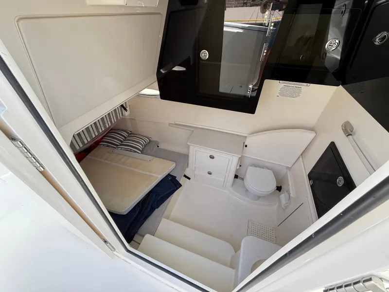 Slide: The Image of 2023 Cobia 350 Center Console cabin interior with bed, storage, and toilet. - 39