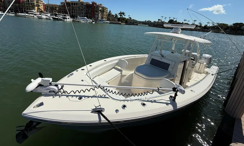 Slide: The Image of 2023 Cobia 350 Center Console boat docked in a sunny marina. - 4