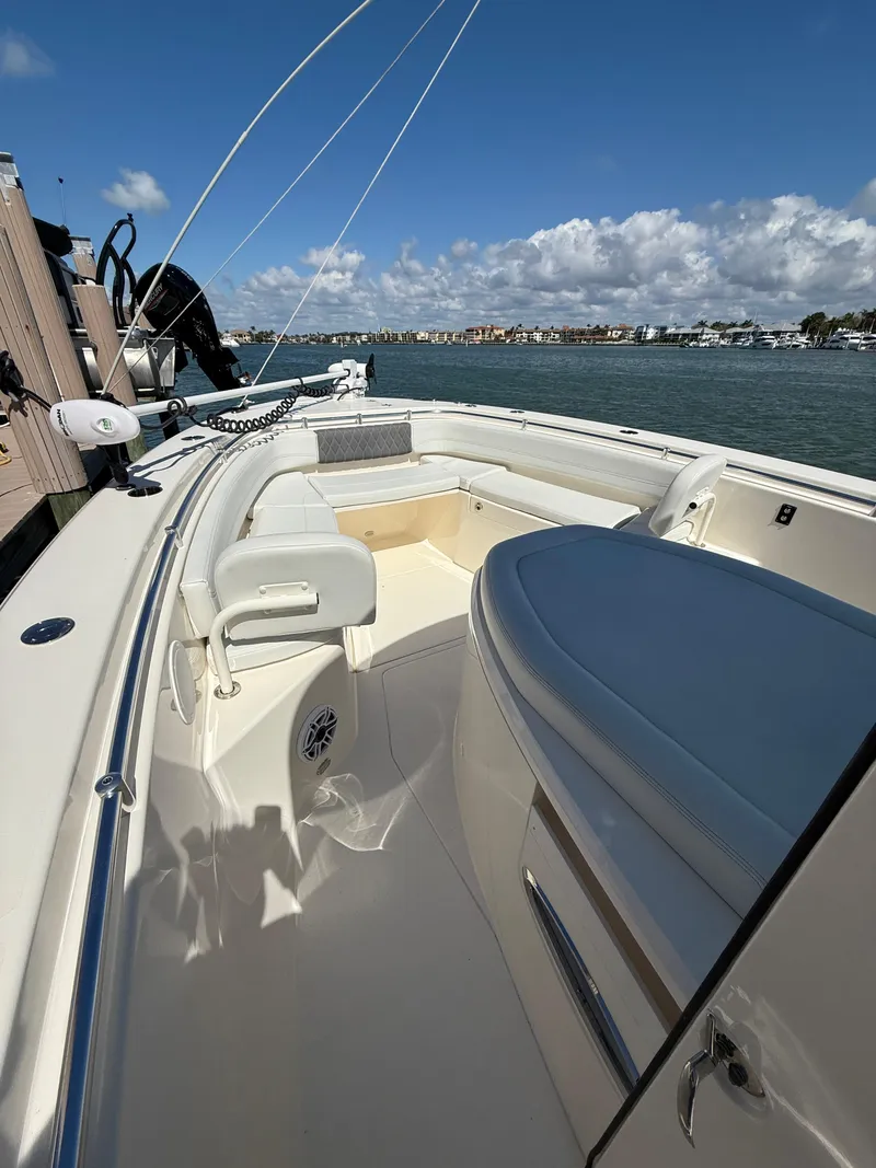 Slide: The Image of 2023 Cobia 350 Center Console boat on water, showcasing spacious deck and seating. - 41