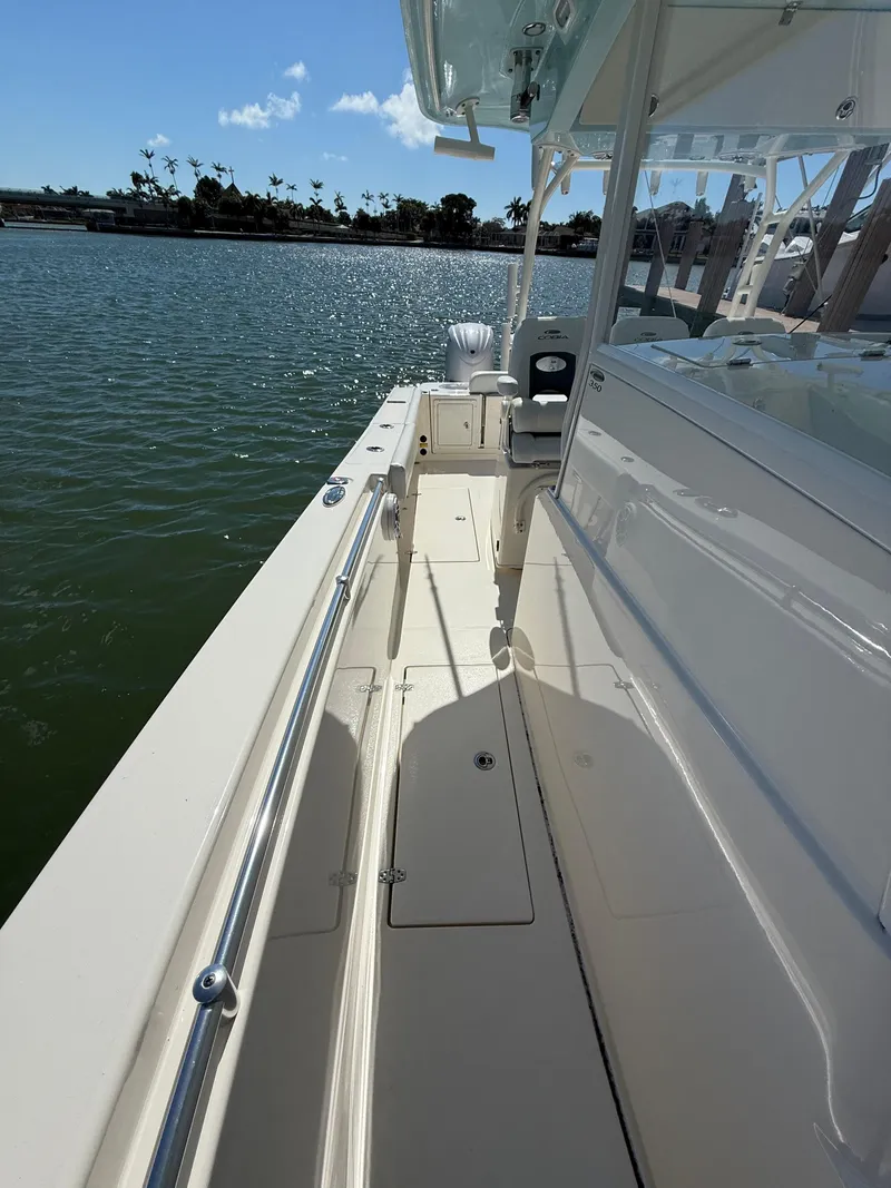 Slide: The Image of 2023 Cobia 350 Center Console boat docked on calm water. - 43