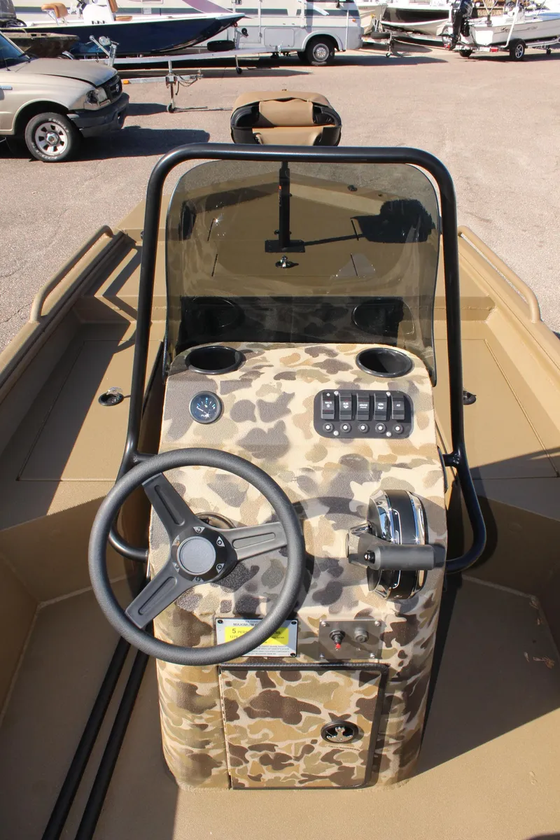 Slide: The Image of 2025 Excel 1860 F4 Shallow Water boat with camouflage console and steering wheel. - 12