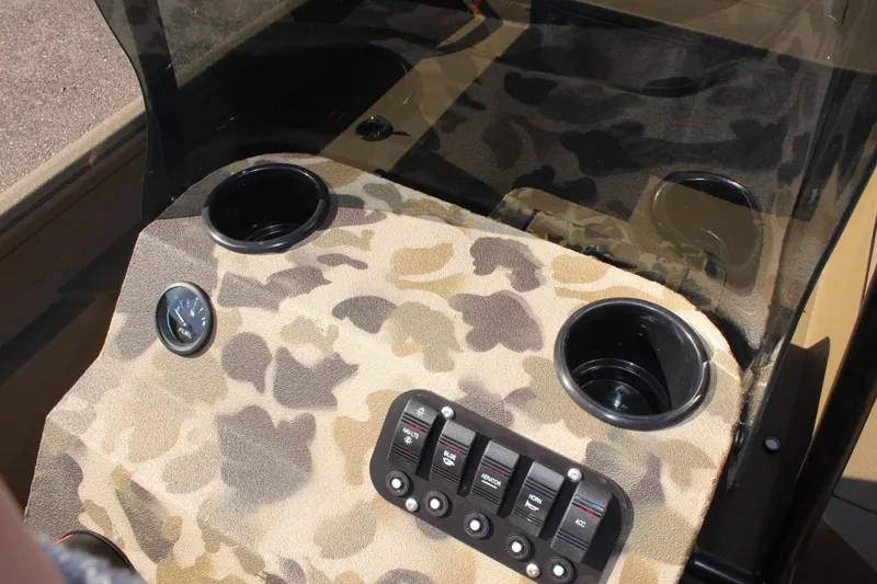 Slide: The Image of 2025 Excel 1860 F4 Shallow Water boat dashboard with camouflage design and control panel. - 13