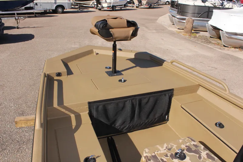 Slide: The Image of 2025 Excel 1860 F4 Shallow Water boat, tan deck, camo seat, docked. - 15