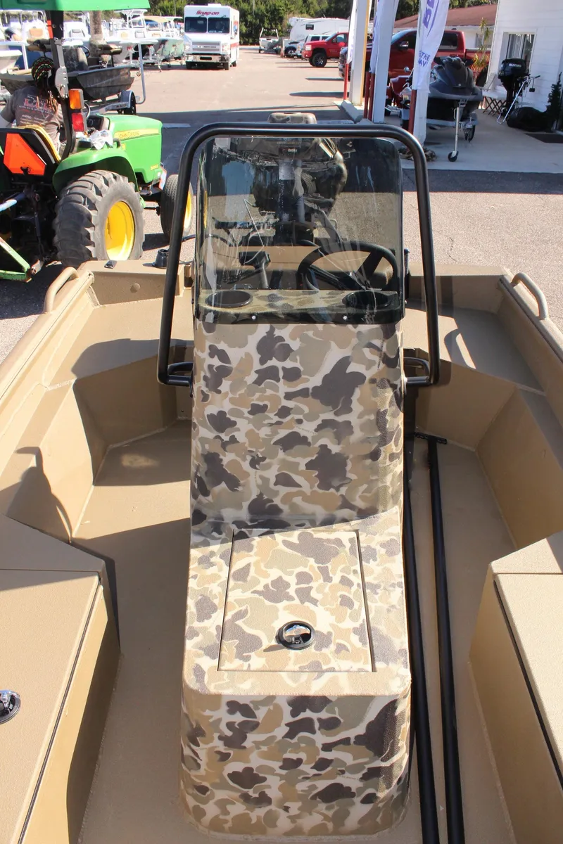 Slide: The Image of 2025 Excel 1860 F4 Shallow Water boat with camouflage console in outdoor setting. - 22