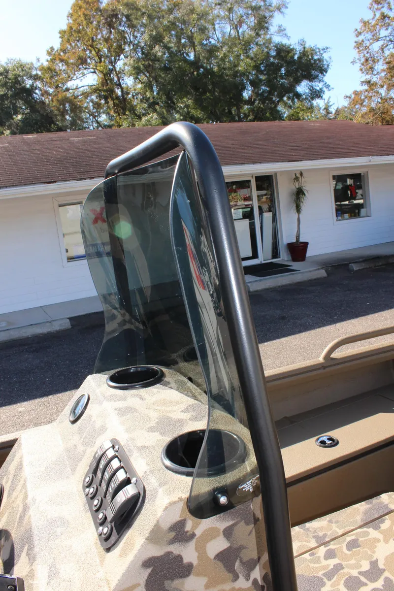 Slide: The Image of 2025 Excel 1860 F4 Shallow Water boat with camouflage design and windshield. - 26