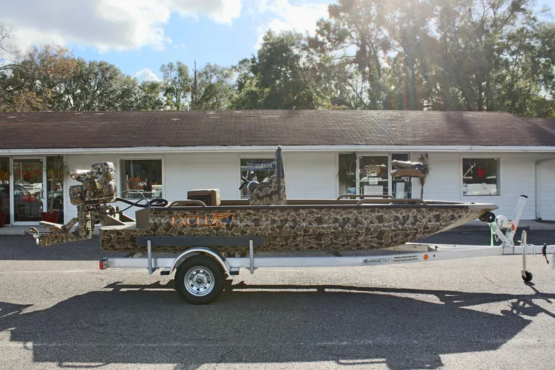 Slide: The Image of 2025 Excel 1860 F4 Shallow Water boat with camouflage design on a trailer. - 4