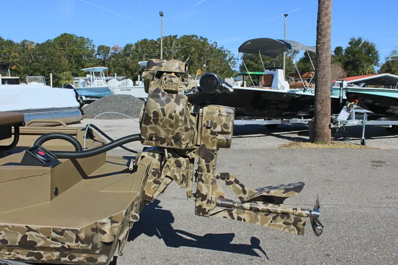 Slide: The Image of Camouflage-patterned Excel 1860 F4 Shallow Water boat, 2025 model, parked outdoors. - 8