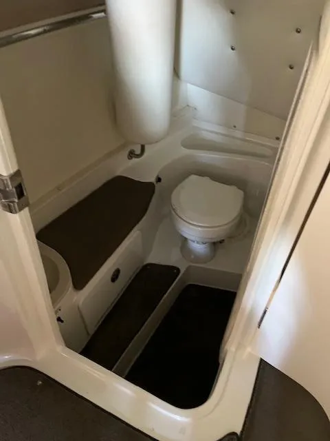 Slide: The Image of 2005 Cobalt 282 boat interior bathroom with toilet and storage. - 10