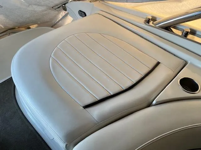 Slide: The Image of 2005 Cobalt 282 boat interior with beige leather seating and cup holder. - 12