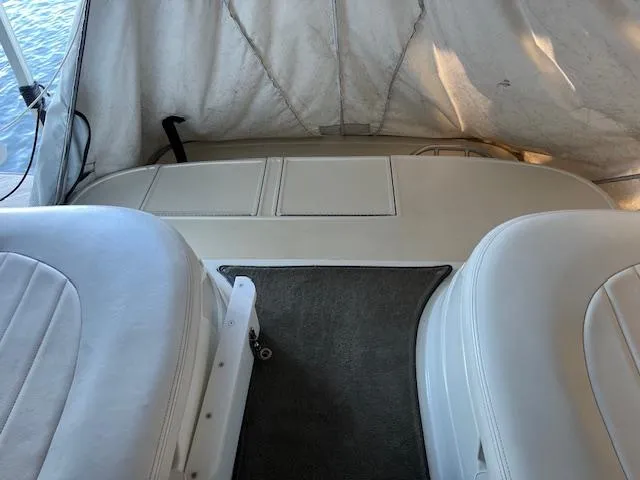 Slide: The Image of Interior of a 2005 Cobalt 282 boat with white seating and covered deck. - 13